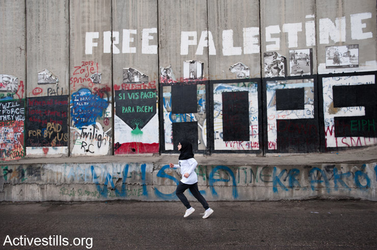 A Palestinian women partipating in  inaugural Palestine Marathon which took place in Bethlehem, West Bank, April 21, 2013. Under the title “Right to Movement” 
